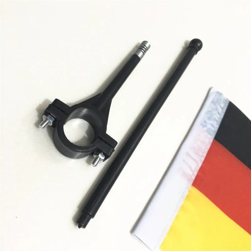 Plastic handlebar pole with attached square polyester cycling flag on a bicycle.