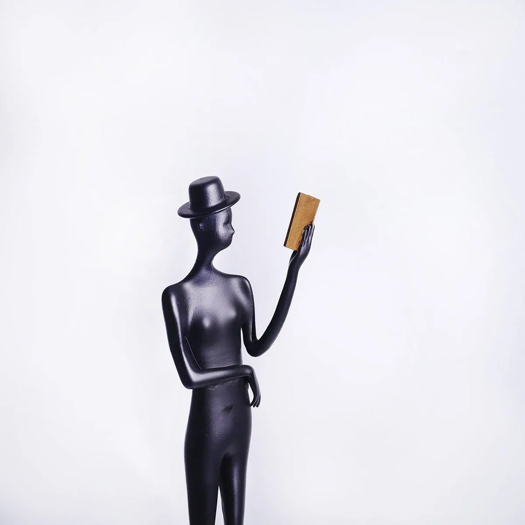 Tall black cast aluminium minimalist character sculpture on a desk, measuring 51cm in height.