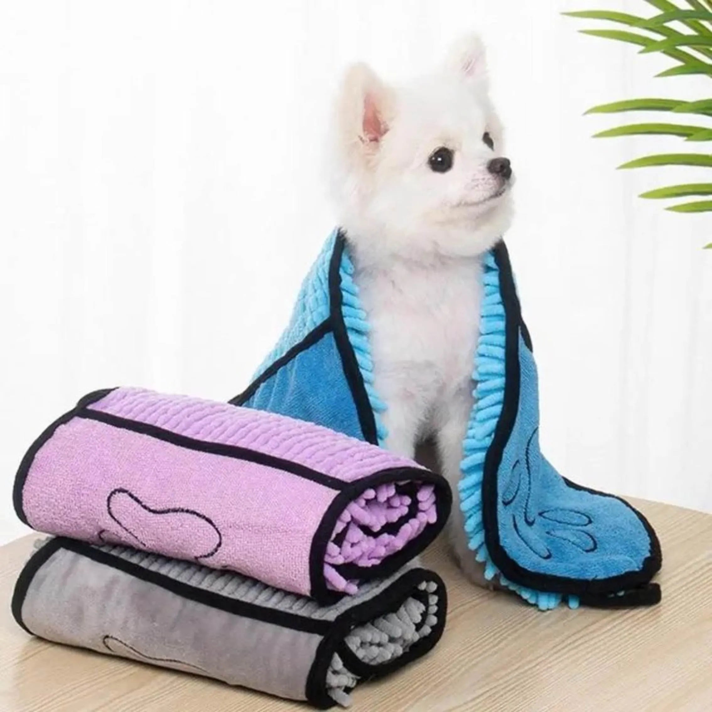 Blue pet bath robe towel for drying a dog after a wash, showing its size and soft texture.