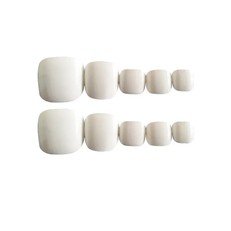 A set of white false nails with a starry sky pattern and glue adhesive.
