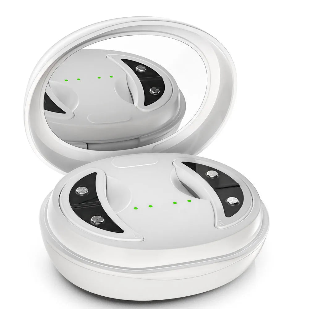 White wireless red light EMS eye and facial massager device on a table