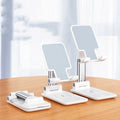Black wireless charging phone desk stand holding a mobile phone at an angle.