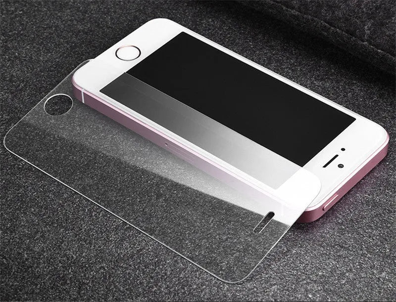 Tempered glass screen protector with 9H hardness for smartphones on a clean surface.