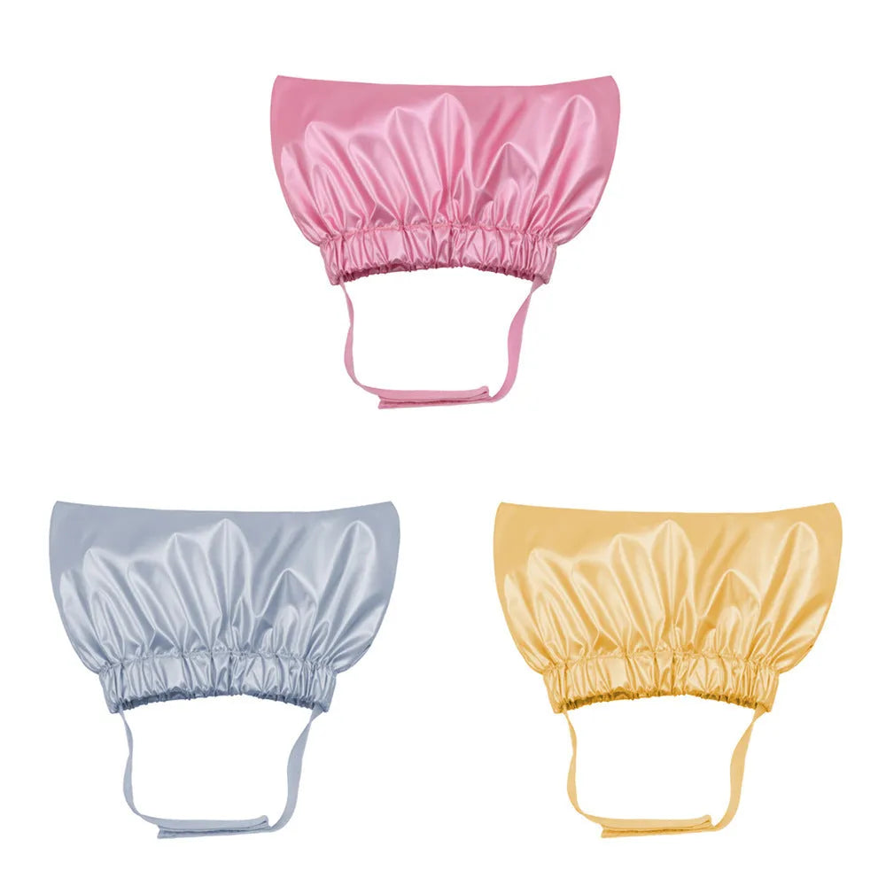 A silver waterproof shower cap for dogs and cats, shown adjusted to fit over pet ears.
