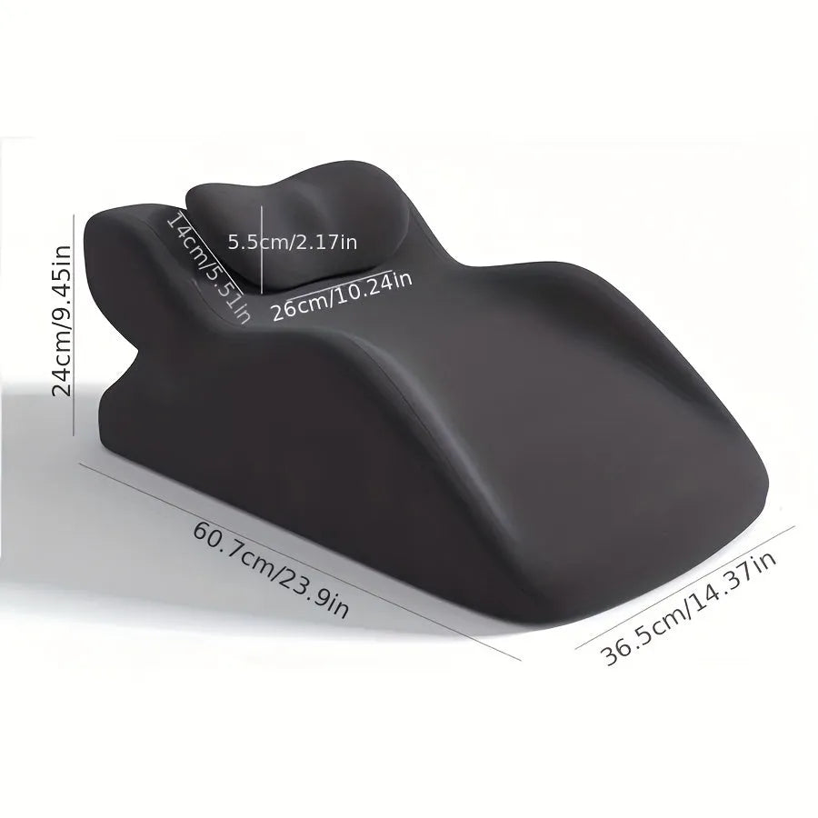 A stomach sleeper pillow shown in light grey, designed for reading or phone use in a prone position.