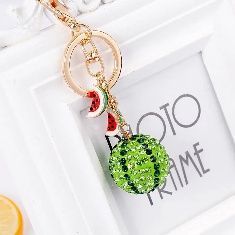 Green watermelon slice shaped zinc alloy keychain measuring 12cm long.