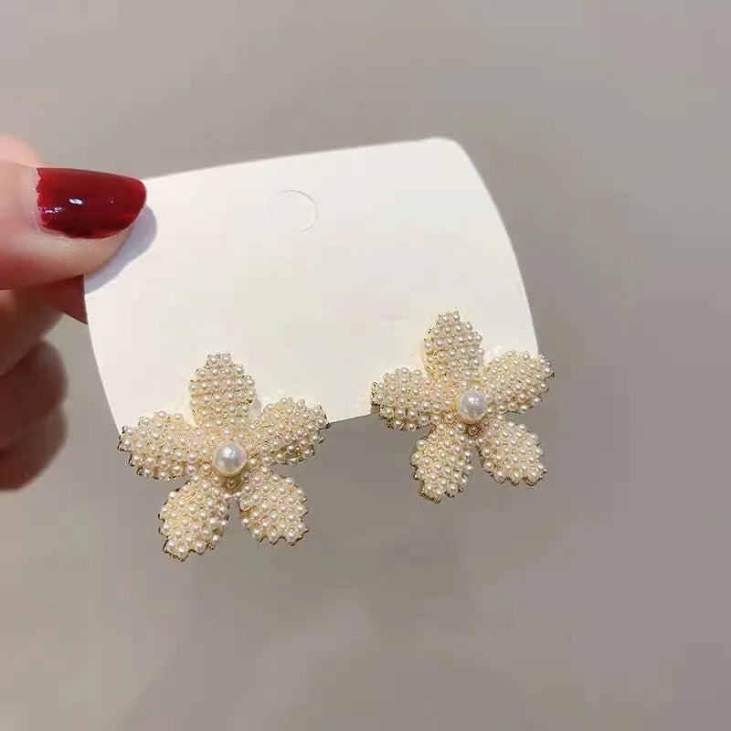Korean-style women's drop earrings with a pineapple starfish pearl design in alloy with stone inlay.