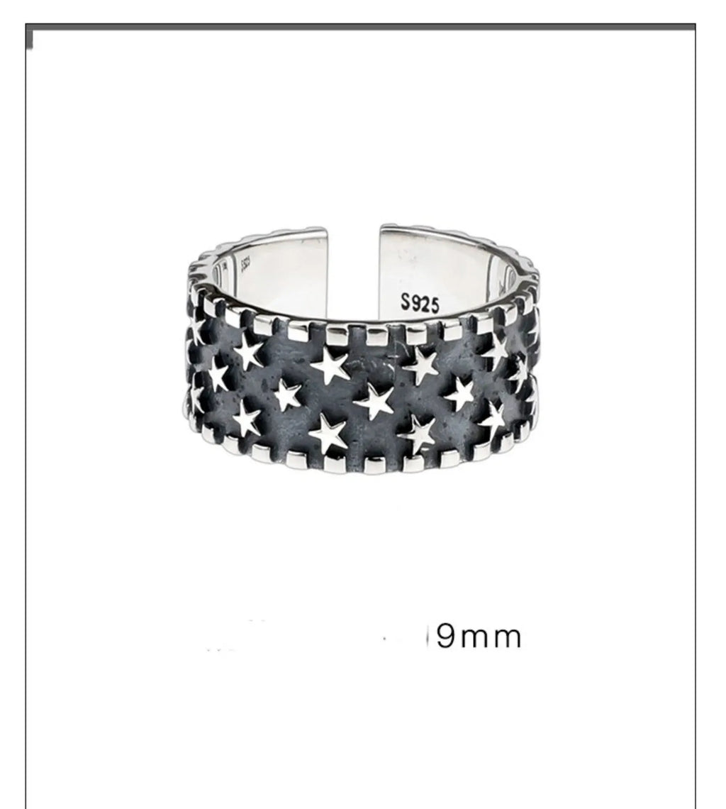 Adjustable sterling silver ring with geometric five-pointed star pattern on band