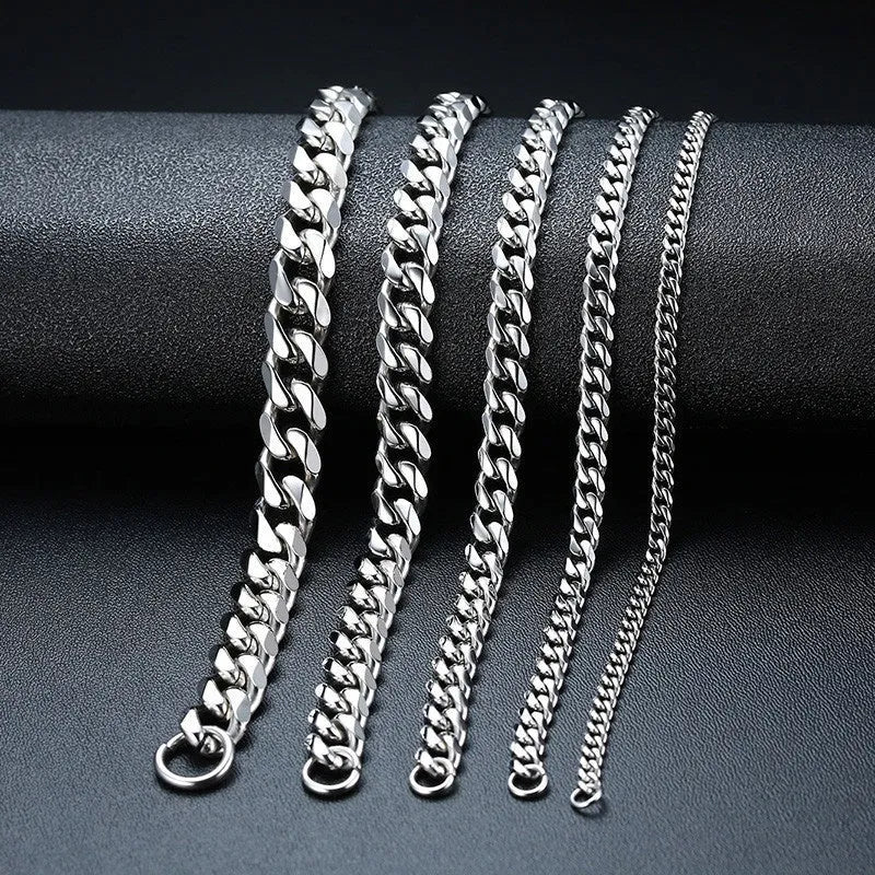 Six-sided geometric Cuban link metal bracelet in gold, black, and steel colour finishes.