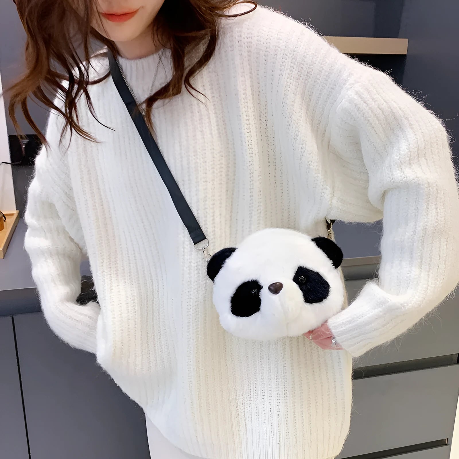 Cylindrical plush crossbody bag with panda head design showing outer sandwich pocket