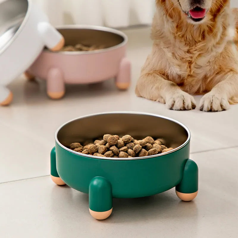 Green stainless steel pet bowl with non-slip base and high foot design on a wooden floor