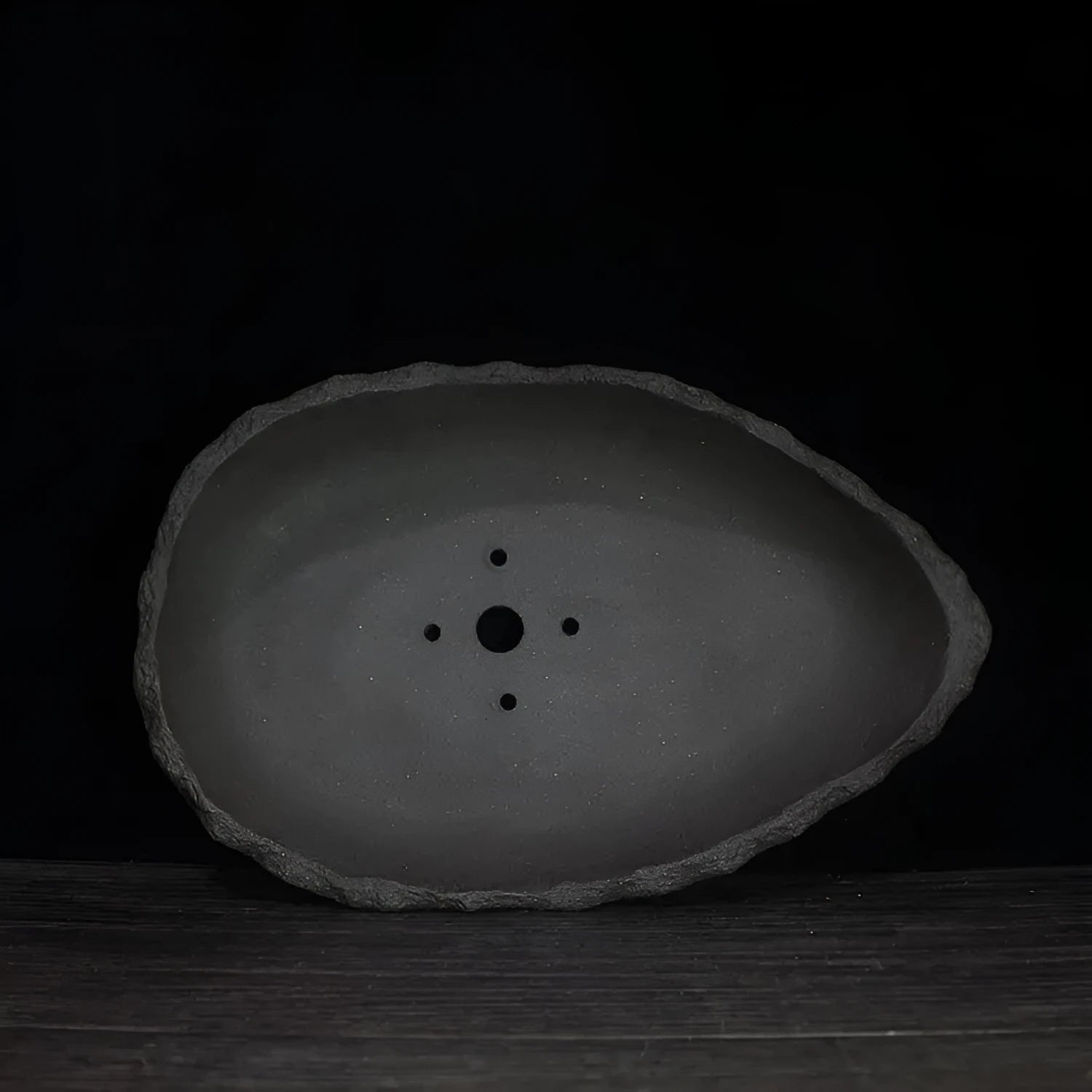 Handmade purple clay flower pot with a unique shape on a floor, showing one of five available style colours.
