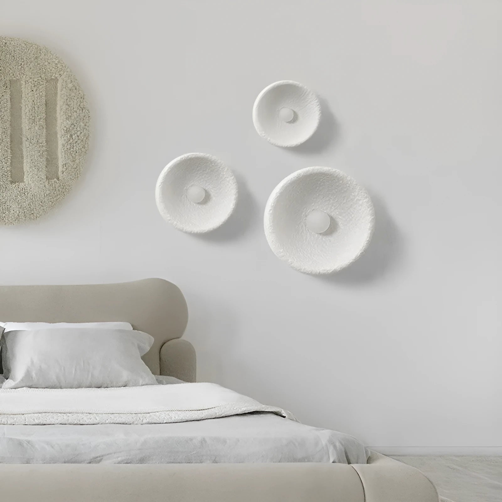 Japanese-style simple silent wall lamp with resin shade in three diameter sizes on white wall