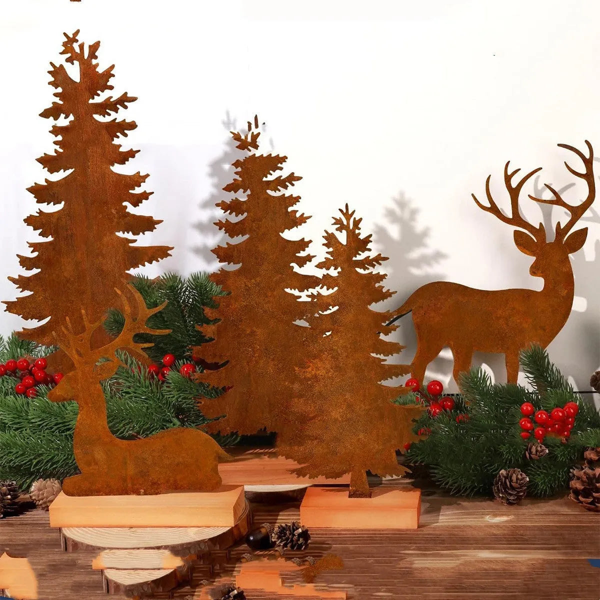 Three rustic metal Christmas tree ornaments with elk motifs in aged metallic finish