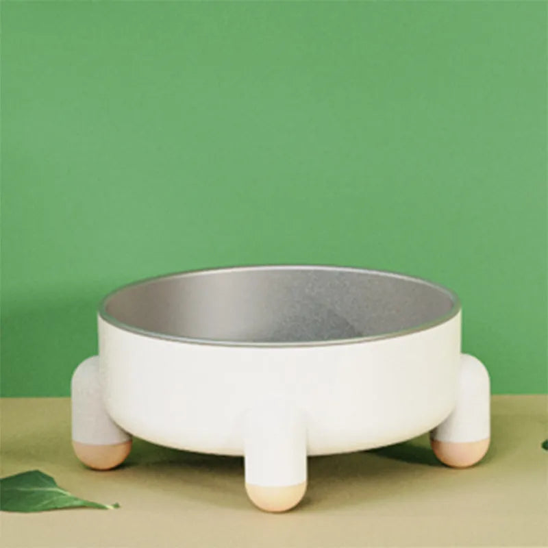 Green stainless steel pet bowl with non-slip base and high foot design on a wooden floor