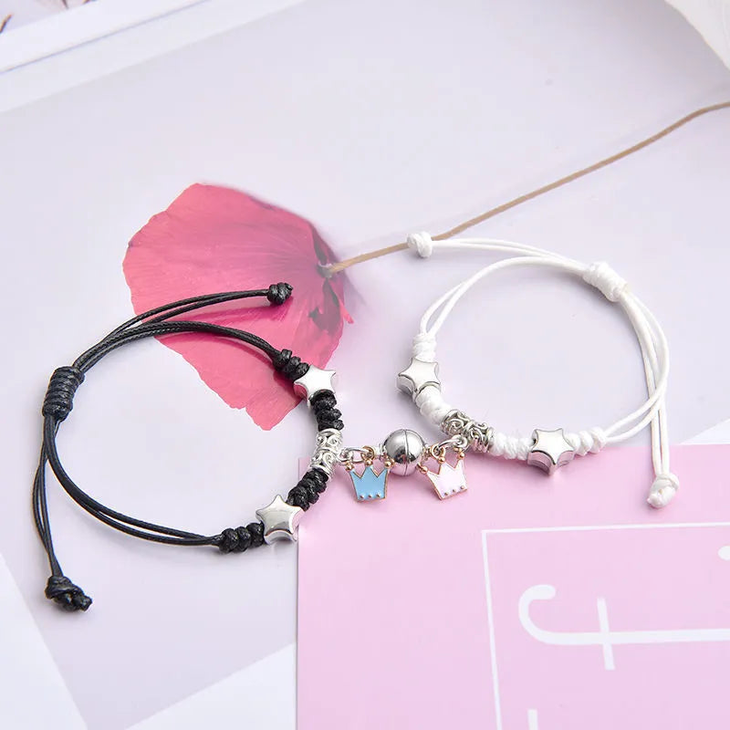 Magnetic couple bracelet pair with alloy electroplating in various designs including clover and crown patterns