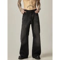 Black loose straight-leg retro jeans on a hanger, showing the front view with zipper fly.