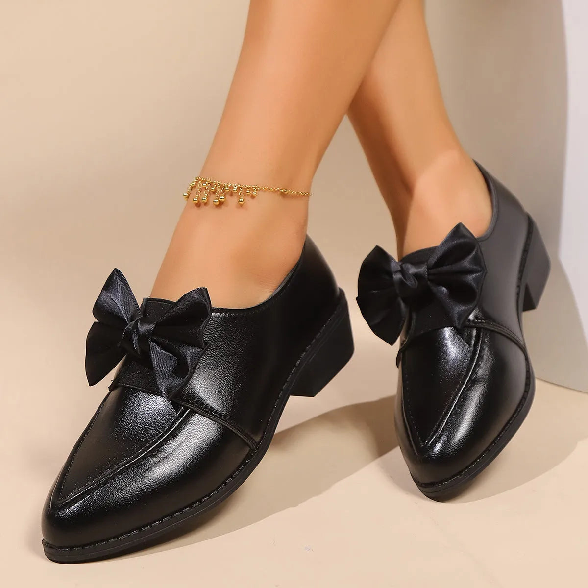 Women's British-style leather shoes with decorative bow detailing on pointed toe