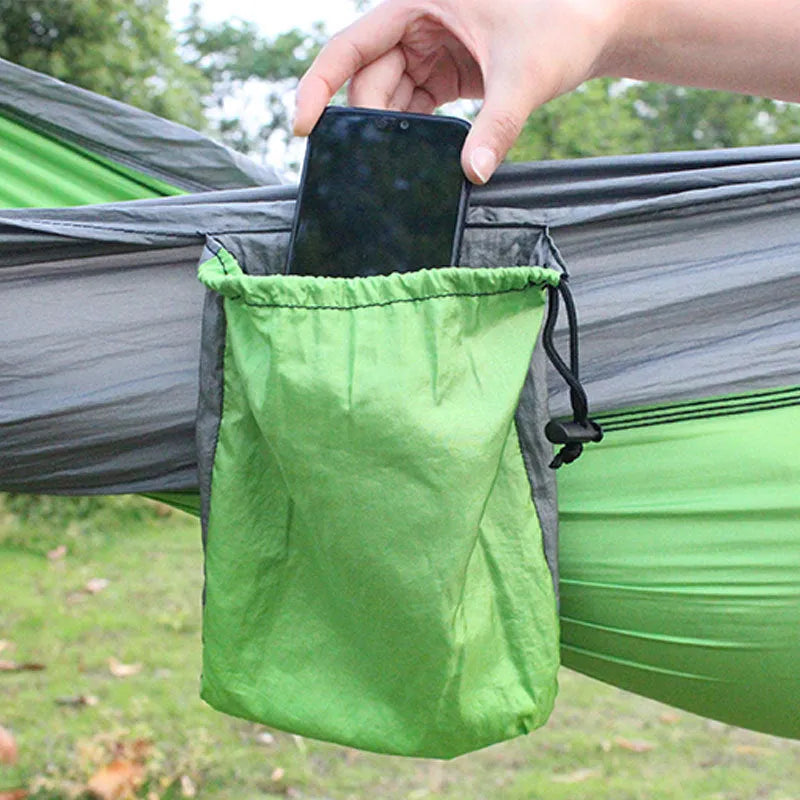Blue parachute cloth nylon camping hammock shown hung between trees with 270cm length