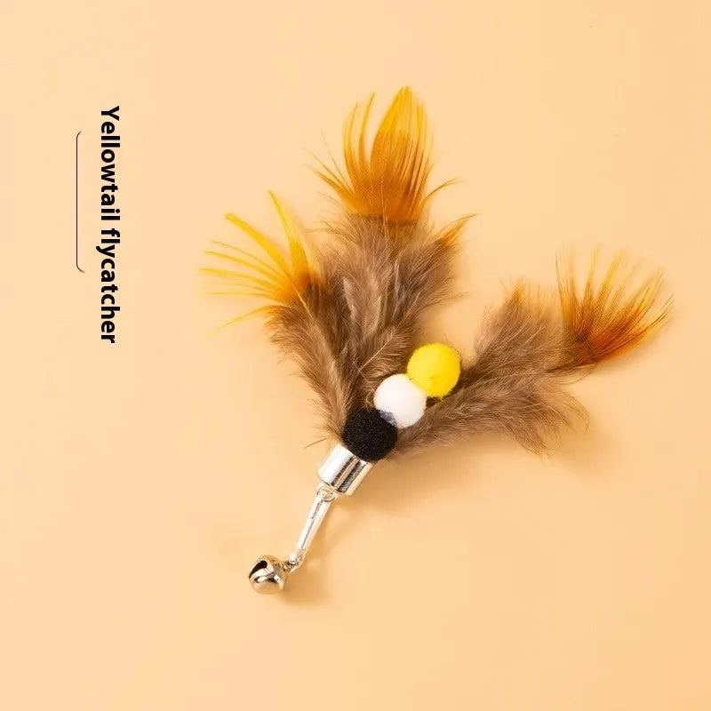 Three steel wire cat toys with small coloured flying insect heads on a table.