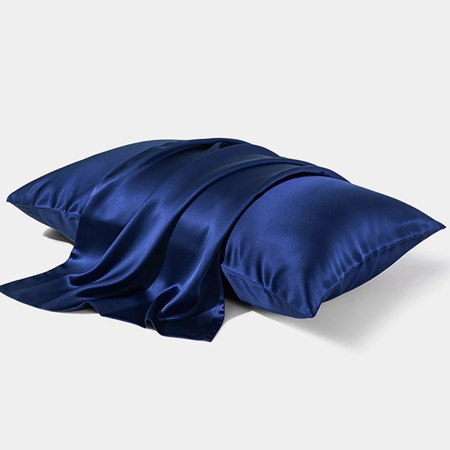 Dark grey envelope closure silk pillowcase on a bed.
