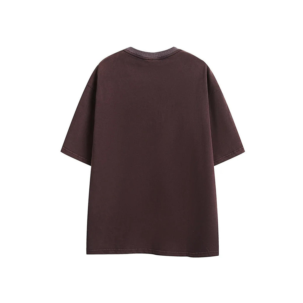 Man wearing a loose black retro short-sleeved cotton T-shirt with an embroidered washed design