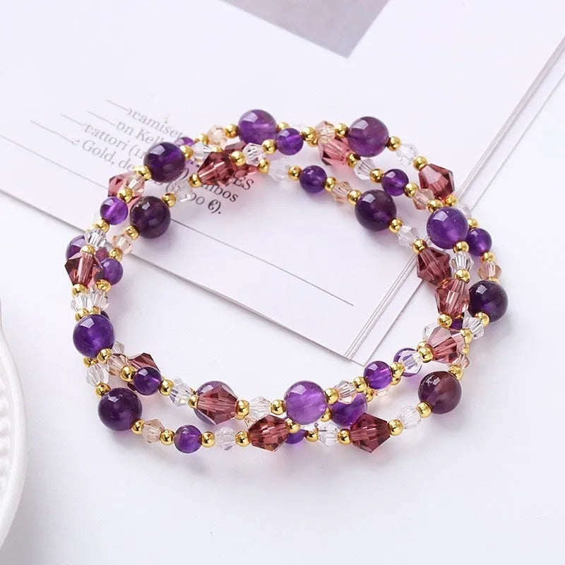 Adjustable bracelet with tourmaline, strawberry quartz, and amethyst crystals in a three-ring design.