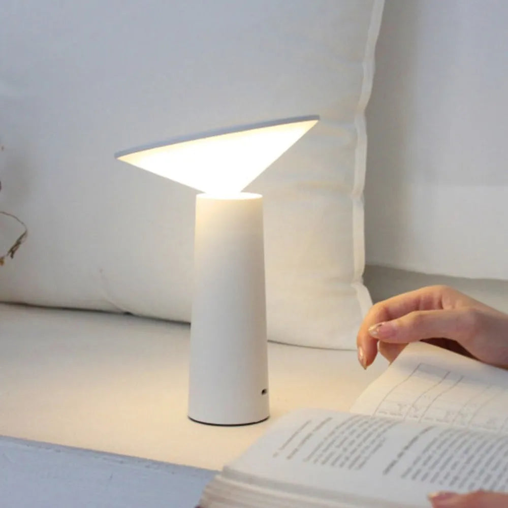 Black and white USB rechargeable LED desk lamp with a touch sensor and adjustable lamp head.