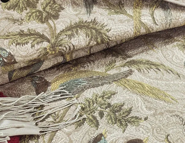Blue American floral and bird pattern quilted cotton bedspread set of three pieces on a bed.