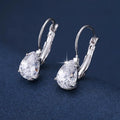 Drop-shaped metal earrings in gold or platinum finish with inlaid gem detailing