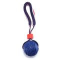 Blue or red natural rubber dog ball with rope attachment, showing textured surface and 29cm total length