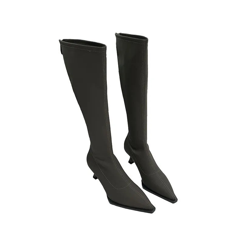 Black pointed toe below the knee stiletto heel boots with a back zipper fastening.