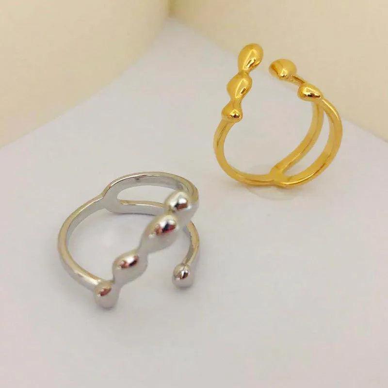 Adjustable brass opening ring with circular sphere element in gold or silver finish