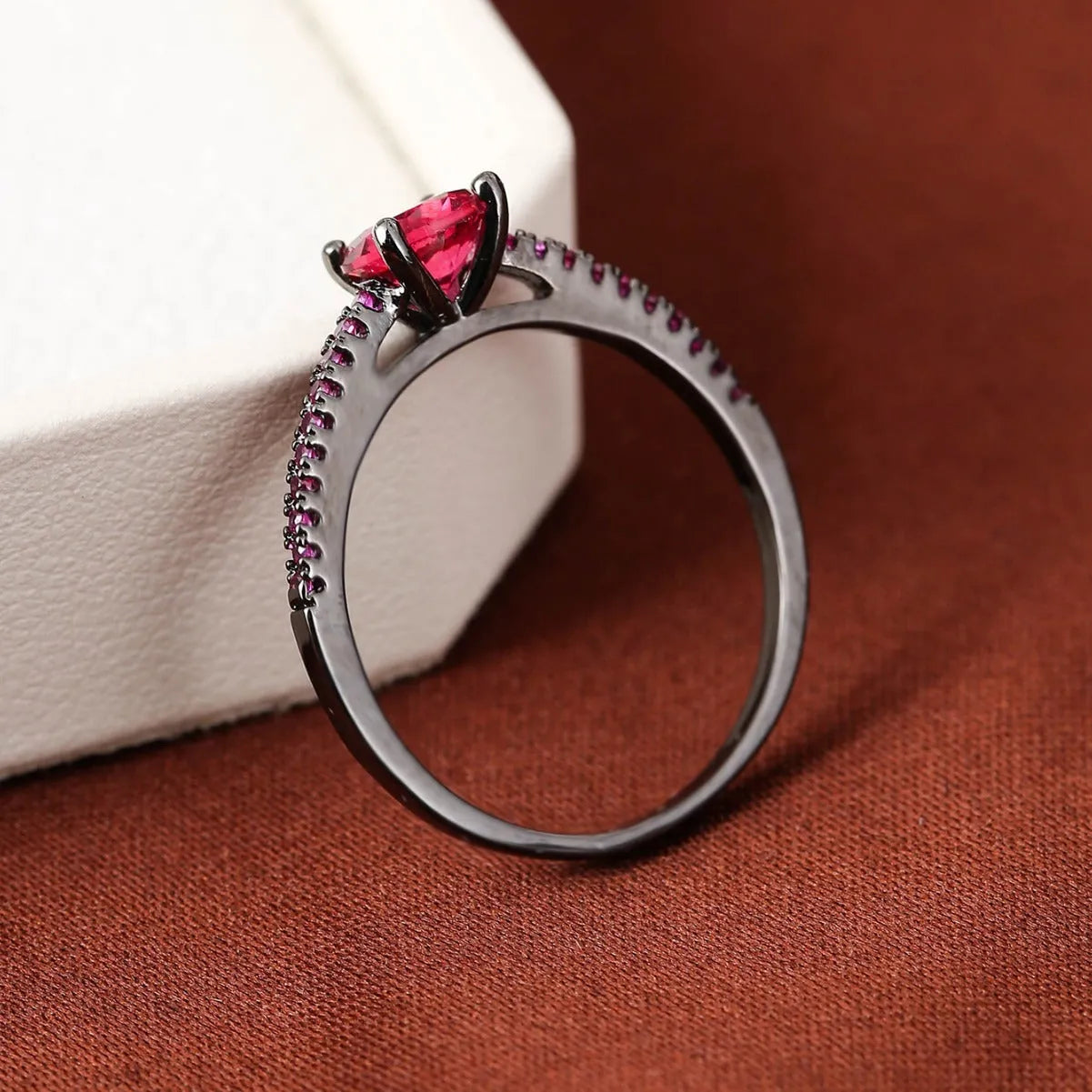 Geometric hexagon copper ring with colourful zircon stones in a metallic electroplated finish.
