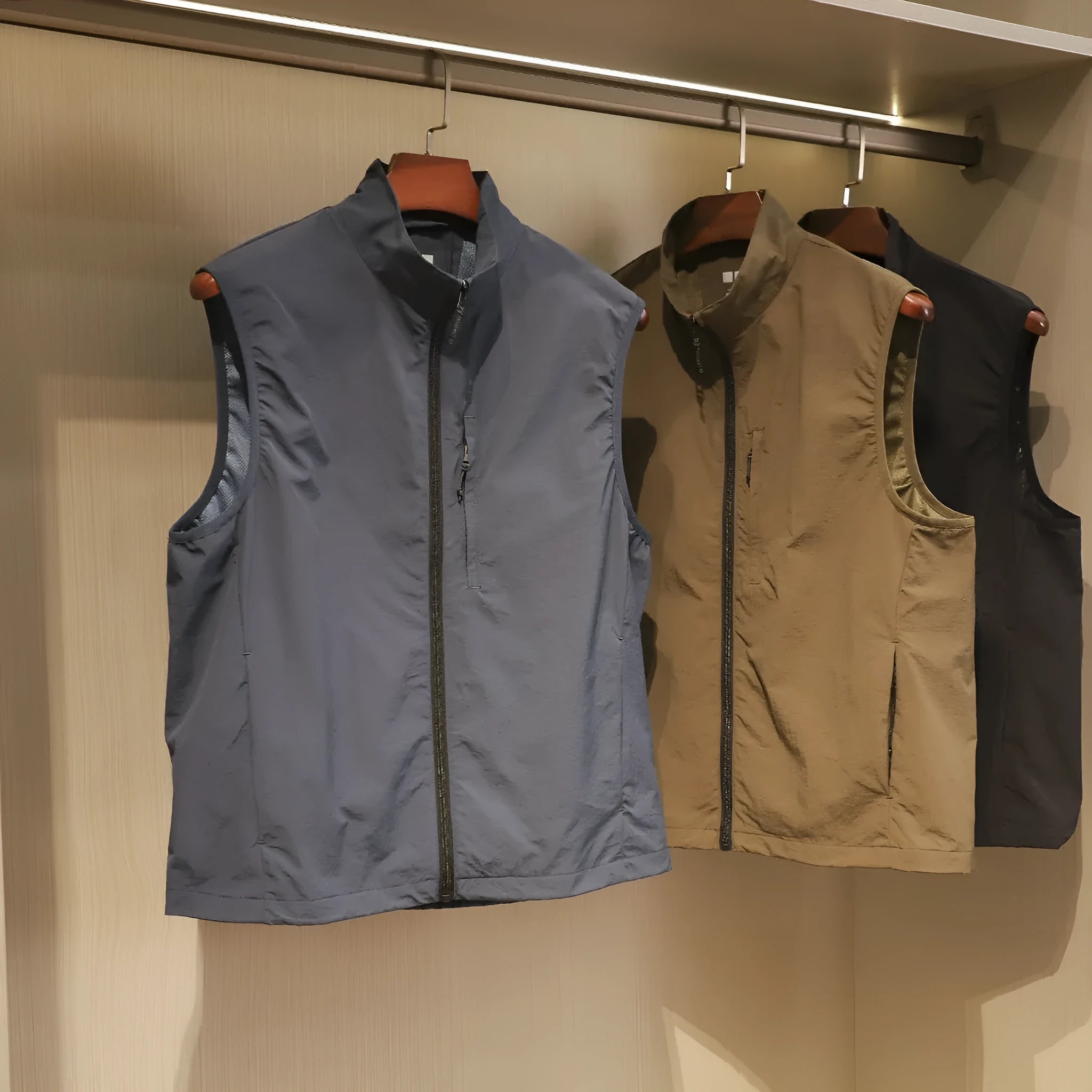 Men's thin nylon vest in straight cut with side pockets, shown in Army Green colour.