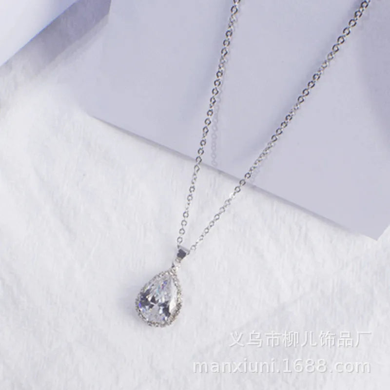Rose gold water drop shape necklace with rhinestone geometric detailing in pink colour