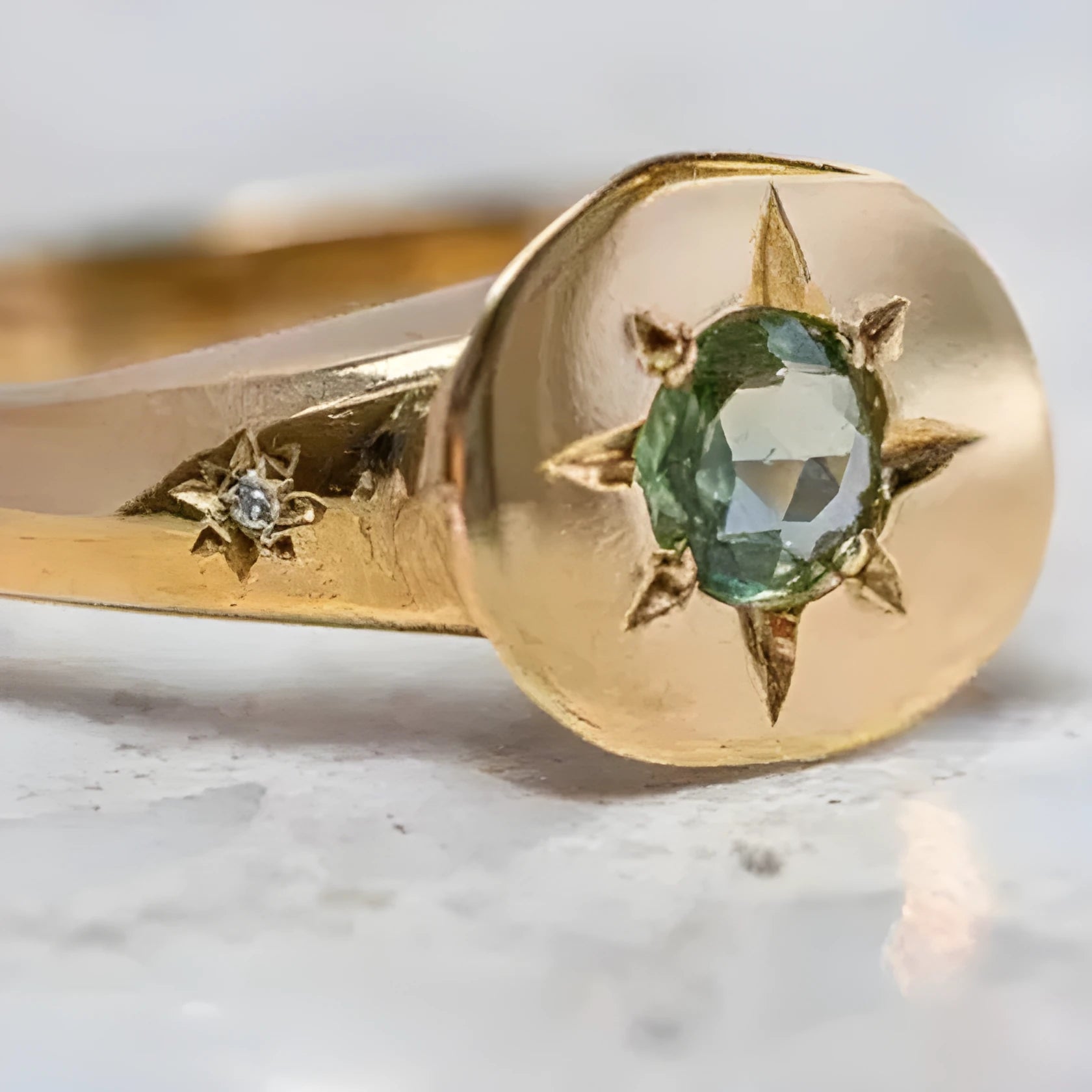 Gold-coloured adjustable ring with a star design and oval zircon stones.