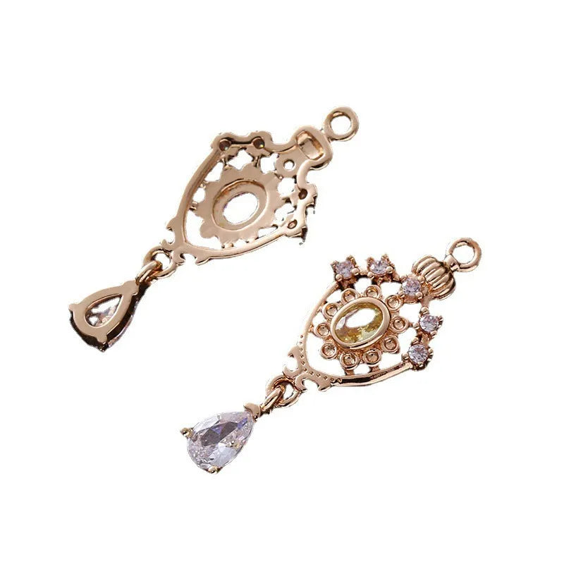 Water drop shaped pendant with crown design and micro inlaid zircon detail in electroplated copper.