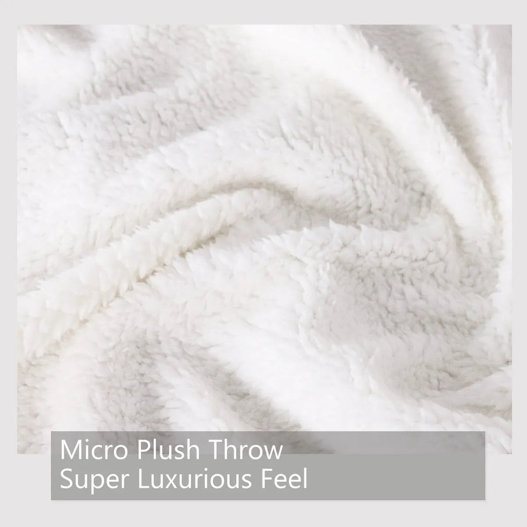 Brown sherpa fleece blanket with wolf head pattern, 150x200cm, on a couch
