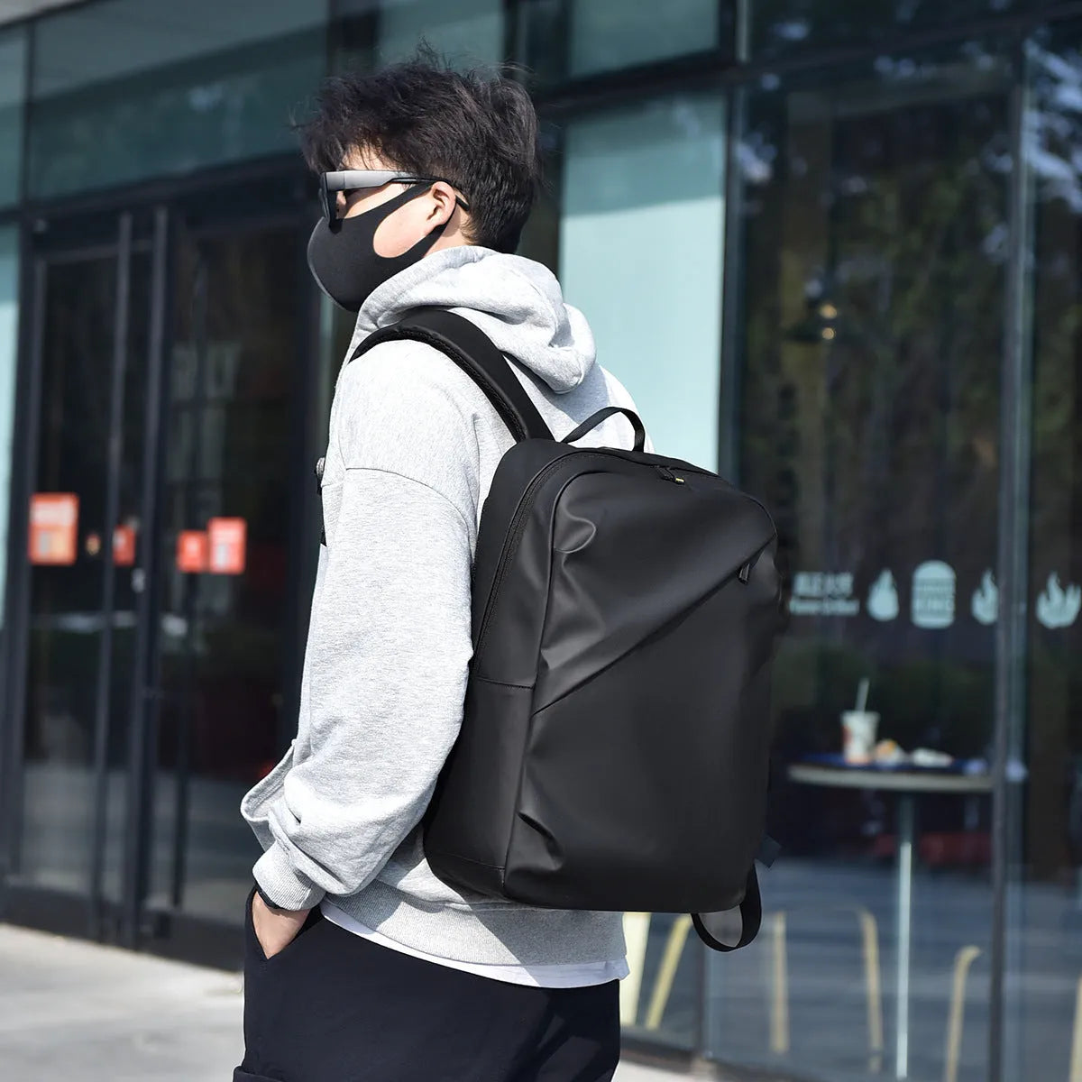 Large black waterproof PU leather backpack for men with sewing thread detailing and computer bag