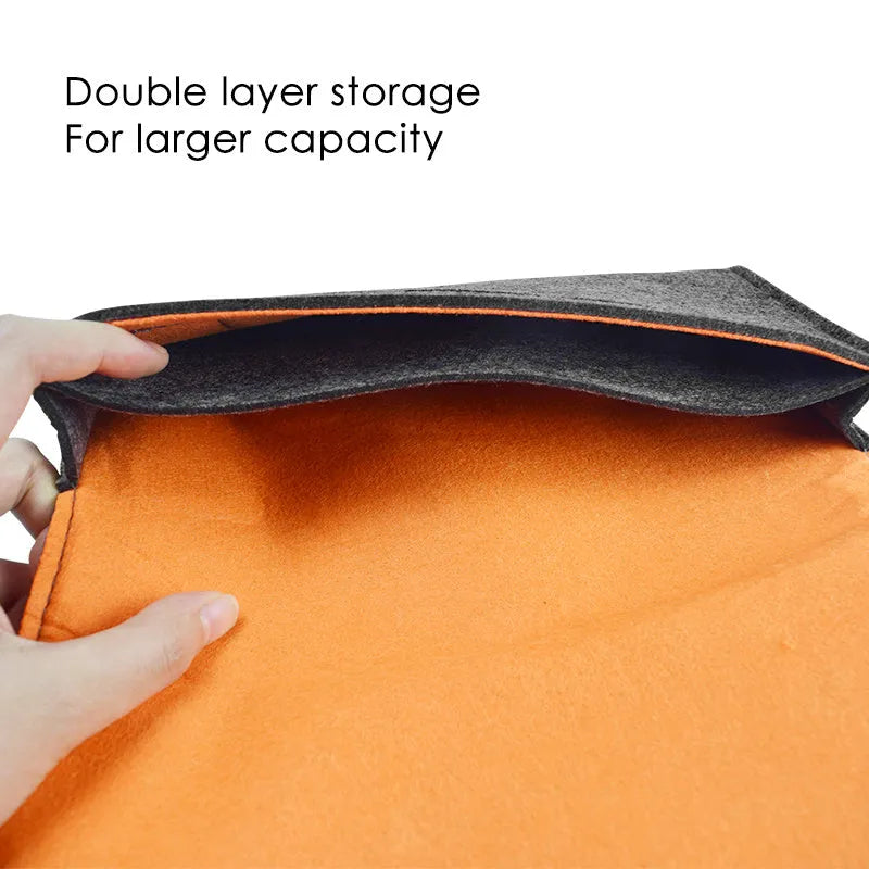 Black felt storage pouch for Nintendo Switch console with game cartridge slots open.