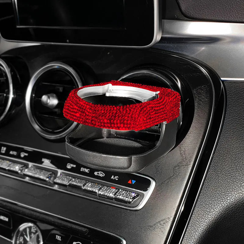 White diamond-encrusted ABS plastic car cup holder bracket mounted on a car air vent.