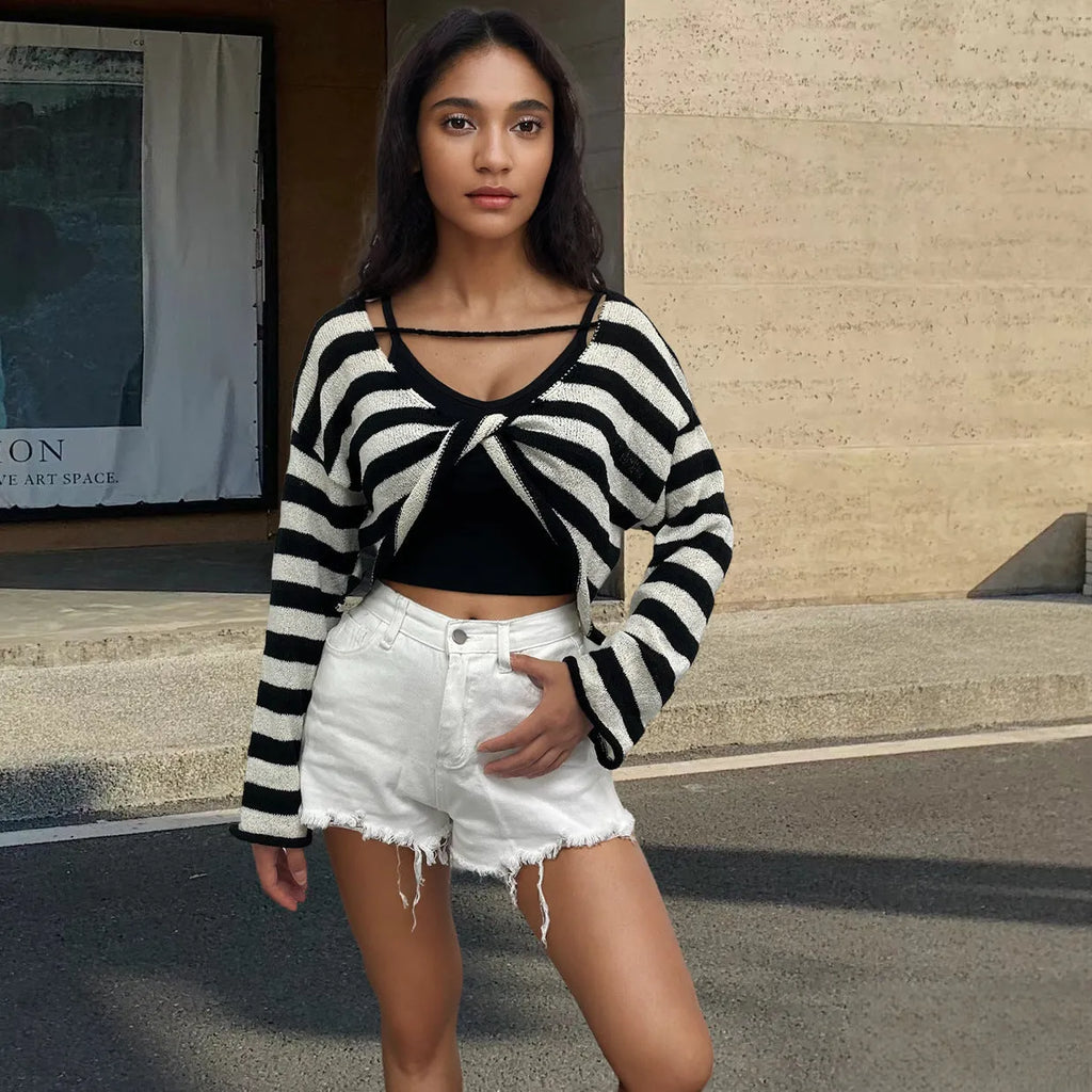 Women's black and white striped cropped long sleeve sweater made from mercerised cotton on a model.