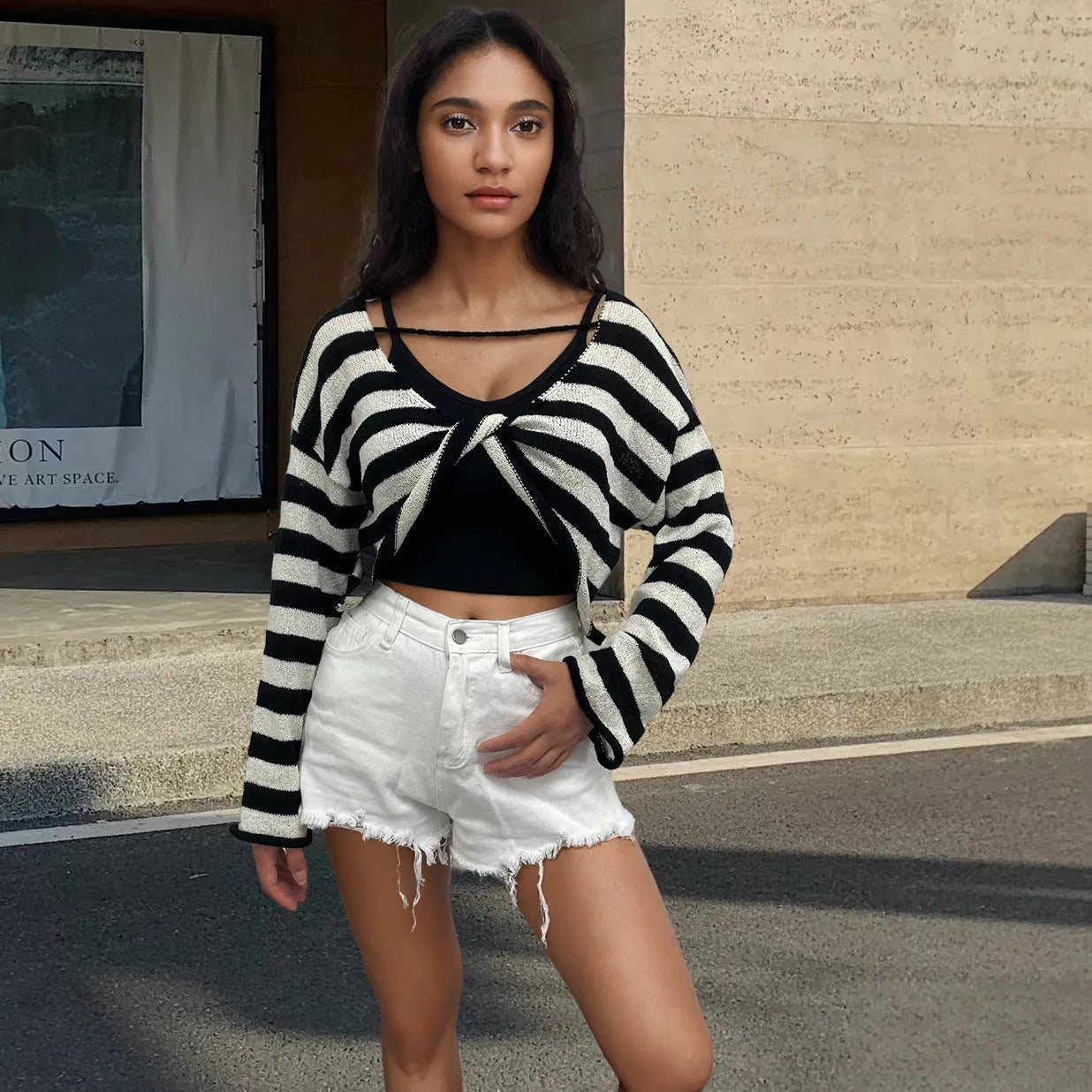 Women's black and white striped cropped long sleeve sweater made from mercerised cotton on a model.