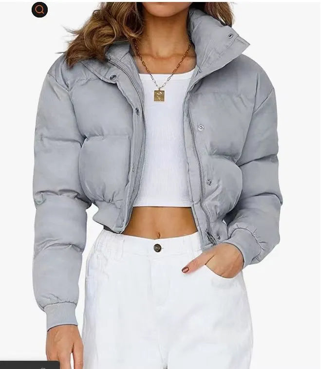 Blue loose fit polyester jacket for women with long sleeves on a hanger.
