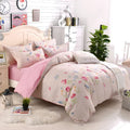 Cotton three-piece bedding set with geometric pattern on duvet cover and pillowcase on a bed