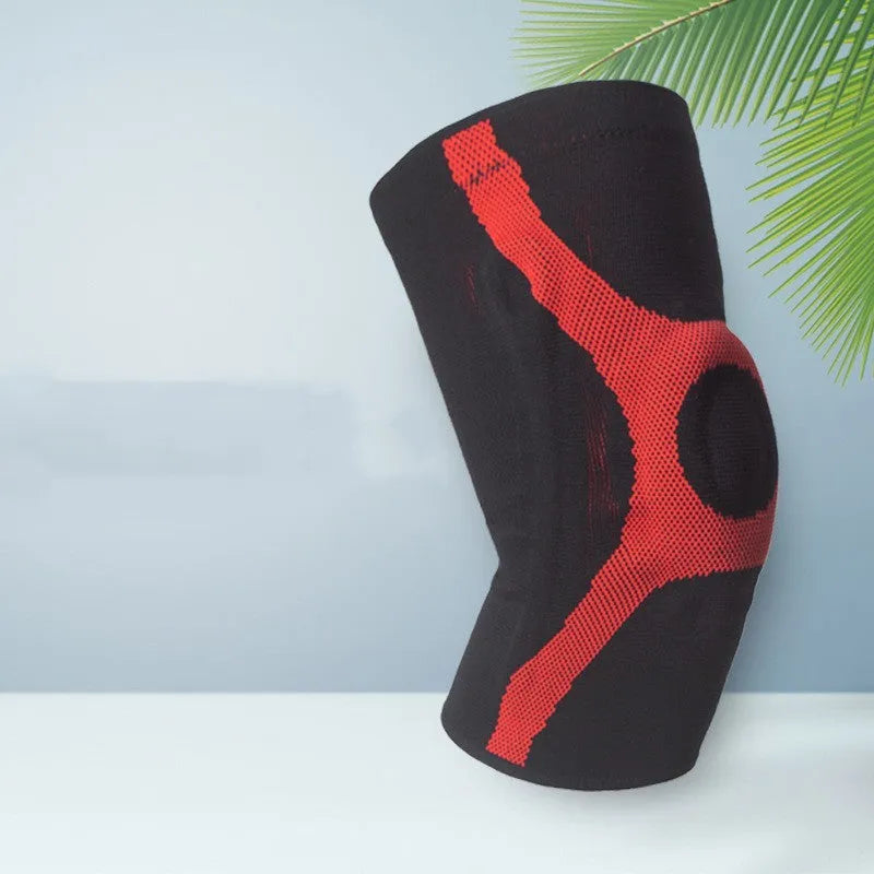 Knitted non-slip sports knee pads in red and grey, showing silicone protective section on knee.
