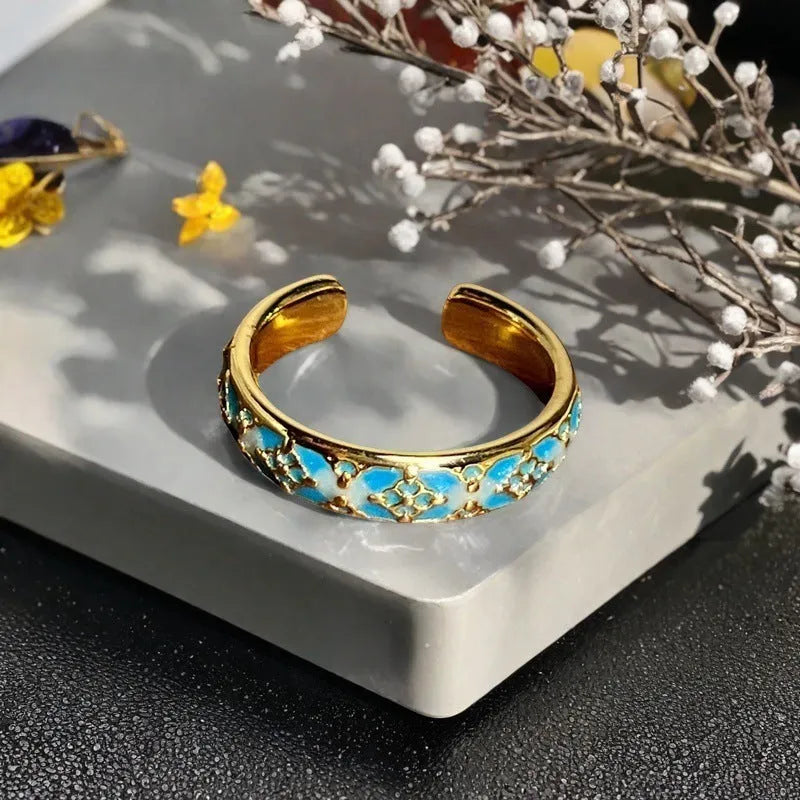 Adjustable copper vintage gourd ring with inlaid zircon stones showing floral and bow design elements