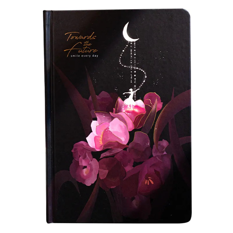 A5 notebook with luminous purple cover open to show pages filled with colour illustrations.