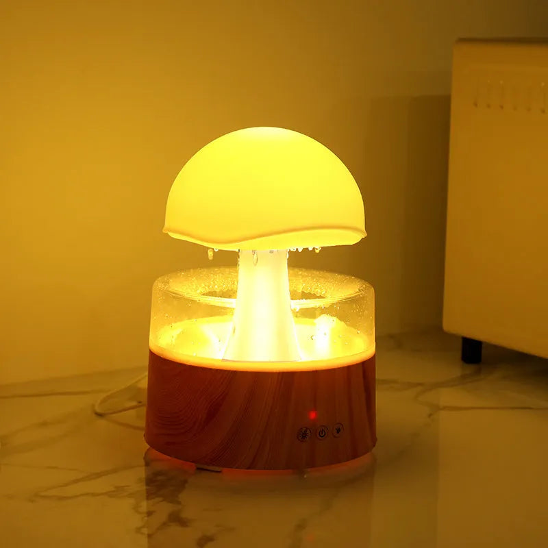 White rain cloud shaped ultrasonic humidifier and aroma diffuser with LED lighting showing rainfall simulation effect